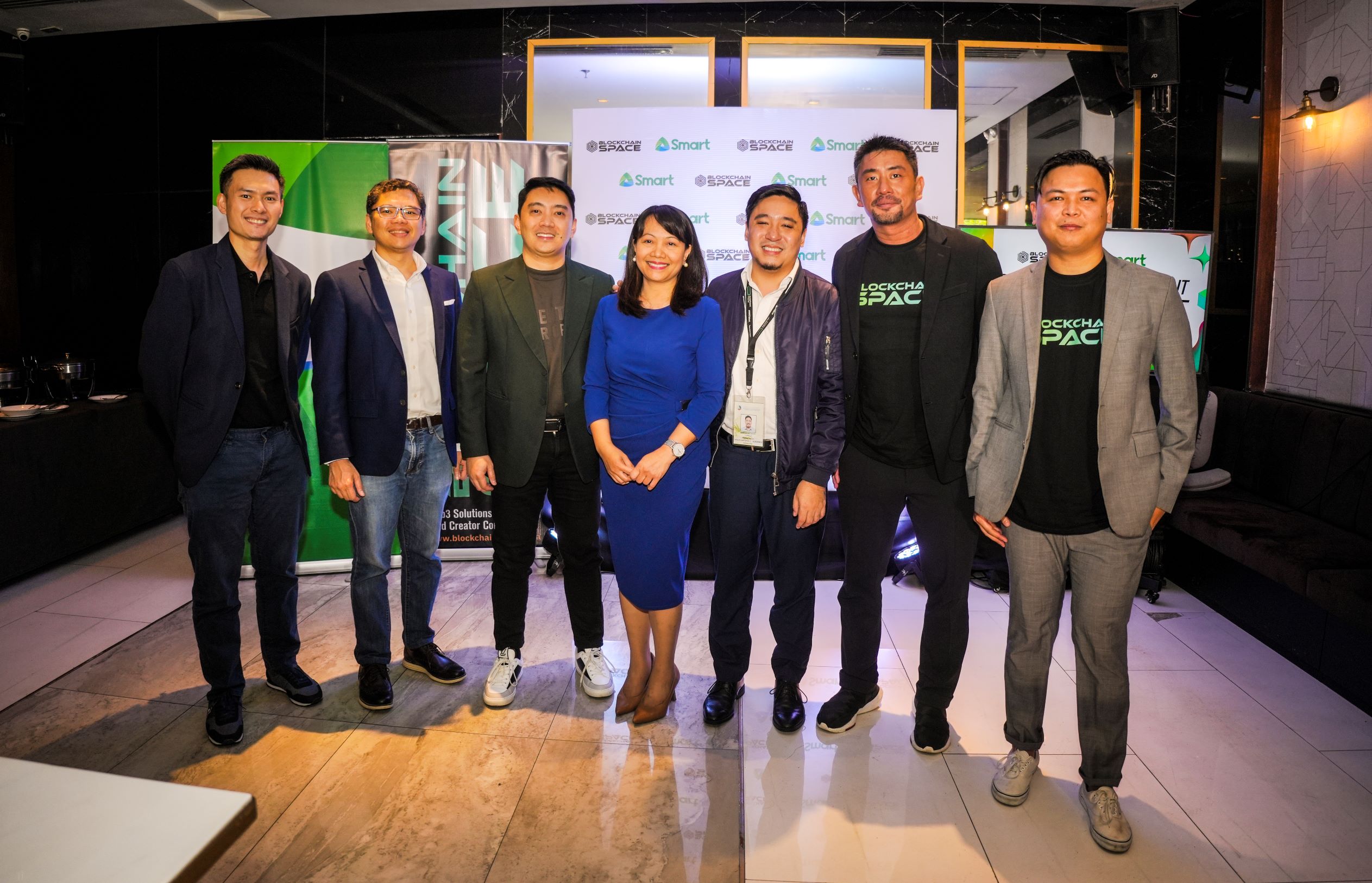Department of Information and Communications Technology (DICT) Director Emmy Lou Delfin (middle) and Project Development Officer III Carlos Albornoz (fifth from left) join the executives of BlockchainSpace and Smart during the press conference announcing the partnership.