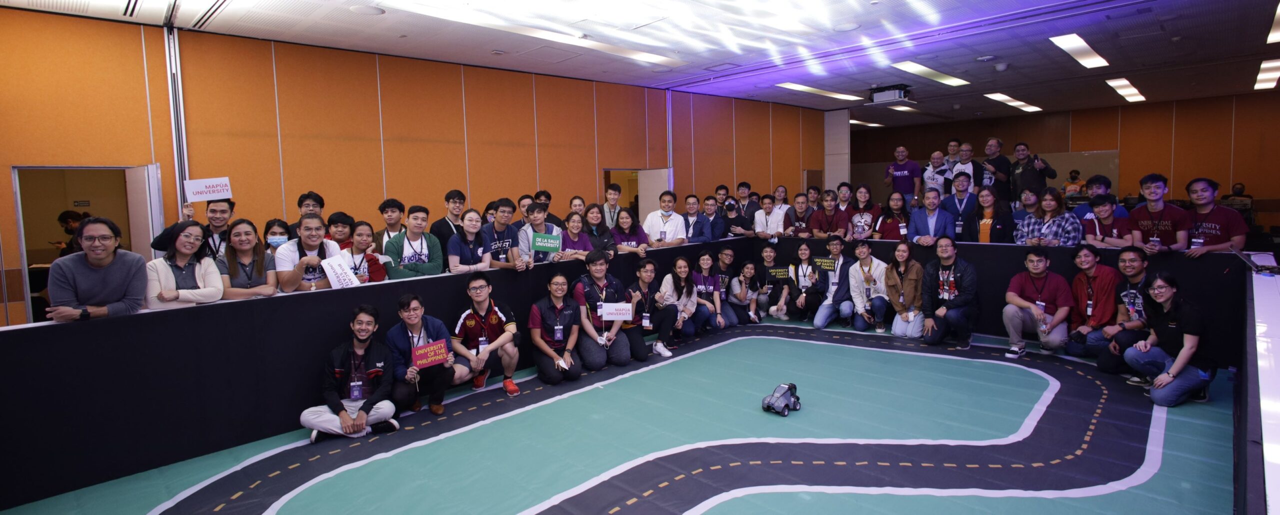 Inter-university AWS DeepRacer organizers from Globe and AWS with participants and guests.